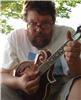 Dave takes time out from a festival to stroke the mandolin - 09/19/05