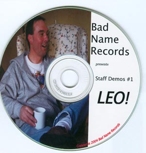 He's got a coffee cup and is sitting in a wing chair